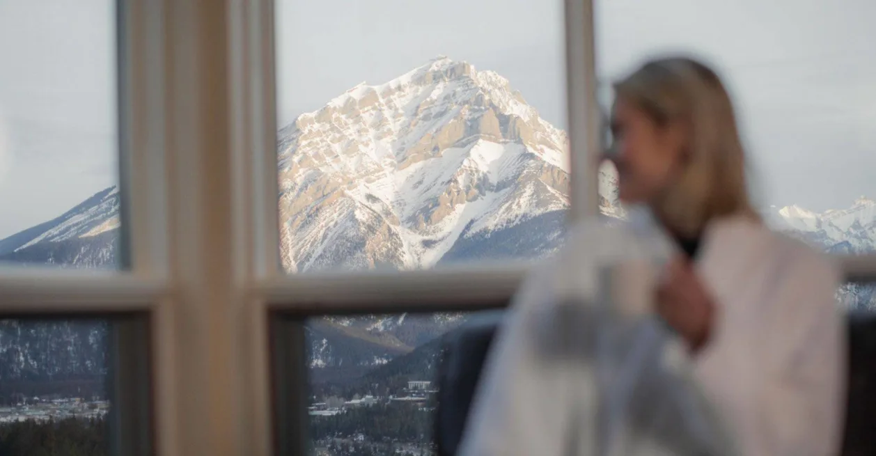 Rimrock Resort in Canada woman in bathrobe looking at view of Banff